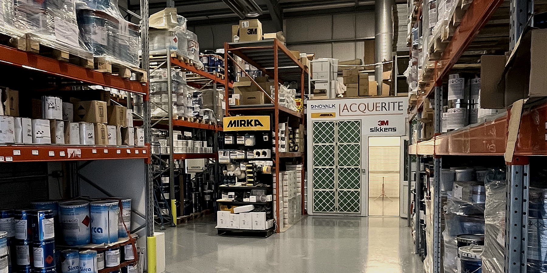 Lacquerite warehouse aisle in Tullamore, with Novalk, Sirca, Mirka and Sikkens stocked on the racks