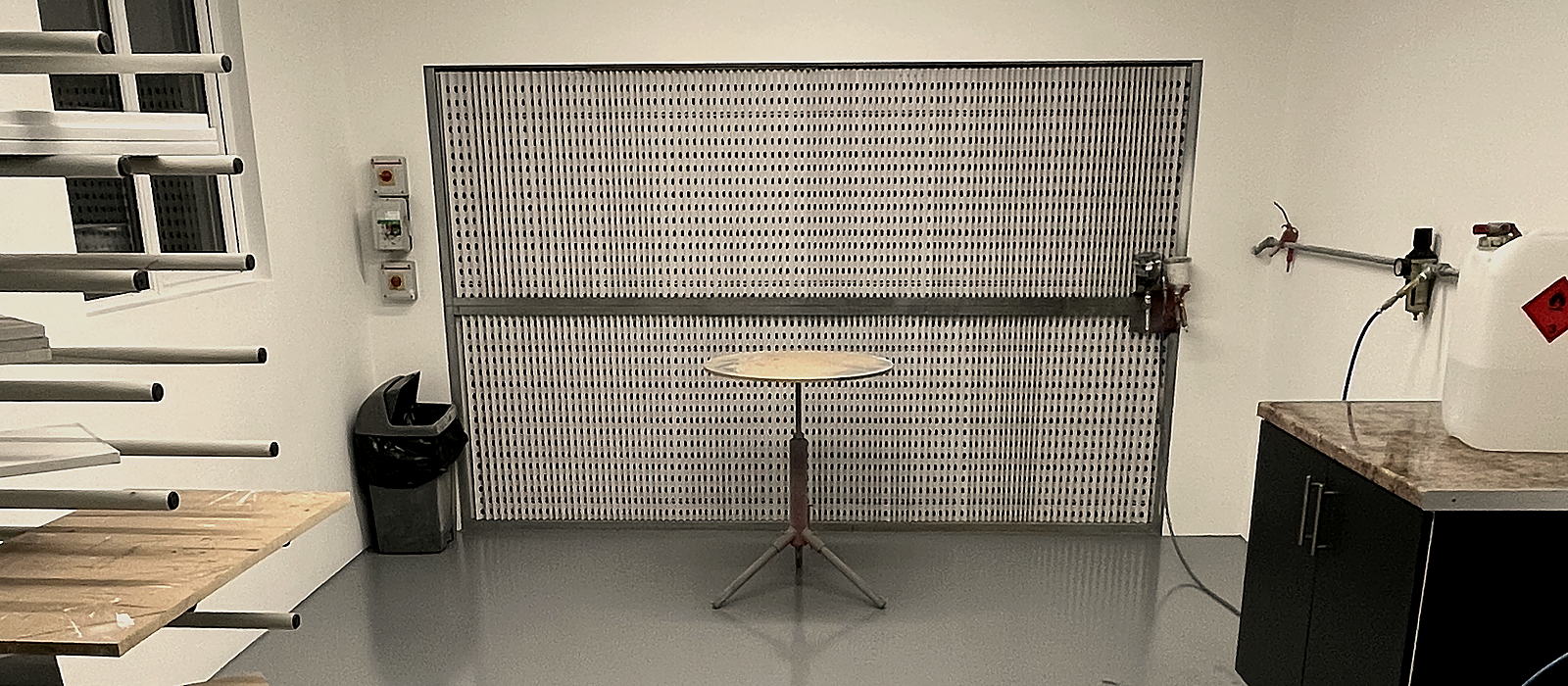Spray booth at Lacquerite, Tullamore, with drying rack, turntable and extraction wall